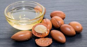 Argan nuts and oil in a small bowl