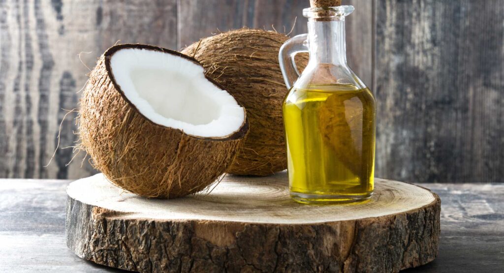 Coconuts and oil in the wooden chopping board