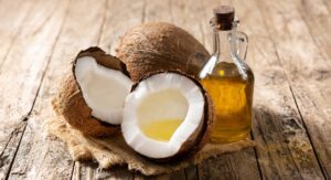 Coconuts and oil in the wooden table