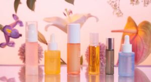 Skincare products line up with flowers on the background