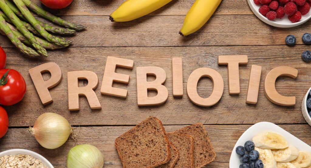 Prebiotic letters with fruits and veggies on the table