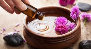 Mineral oil in a wooden bowl with flowers