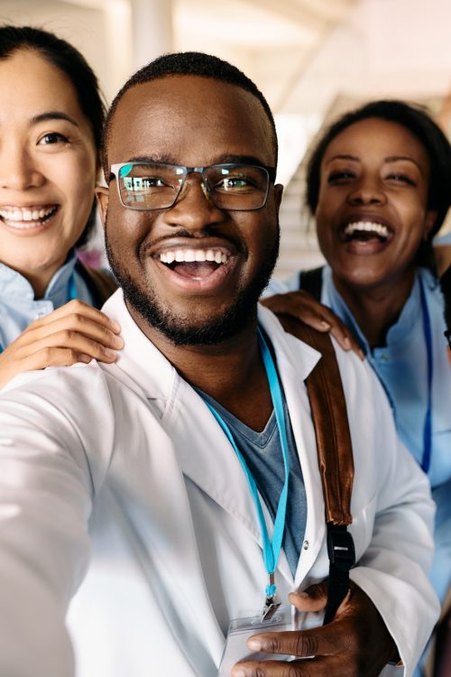 Multi-ethnic group of happy students having fun wile taking selfie at medical university.