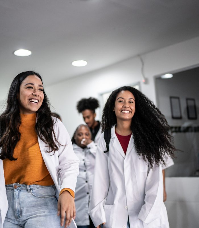 Teacher and students walking in school or university corridor